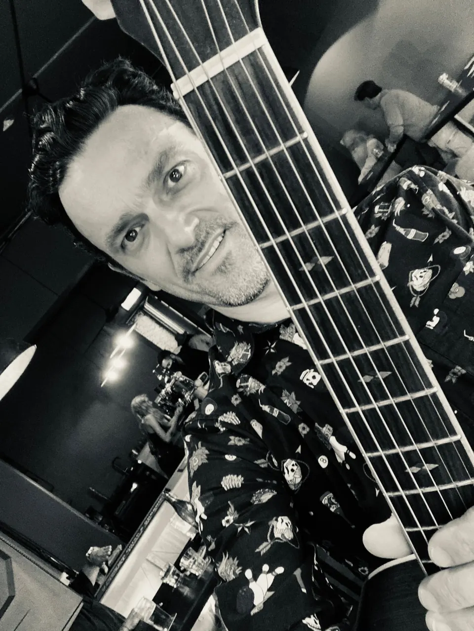 Close-up of Milano with the neck of his guitar